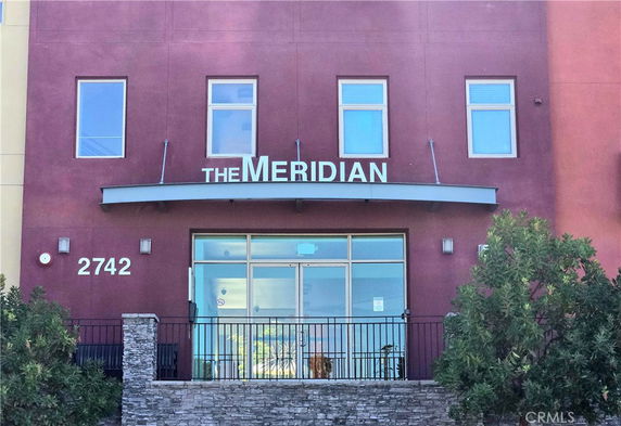 Front view of a building with the name 'The Meridian' displayed above the entrance.