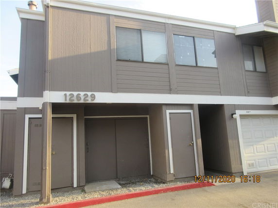 Front view of a two-story building with a garage.