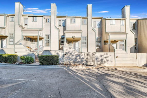 Front view of multi-story townhouses with individual entrances.