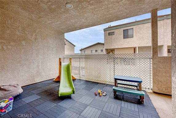 Covered indoor play area with a small slide and child-sized picnic table.