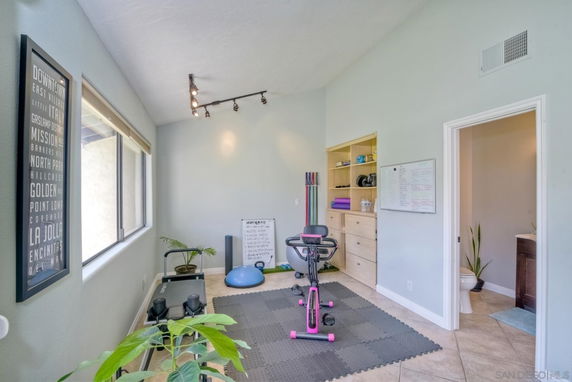 Room with exercise equipment and yoga mats