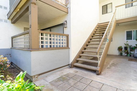 Exterior view of a two-story building with a staircase.