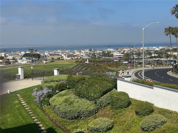 Panoramic view of a coastal area with buildings and ocean in the background.