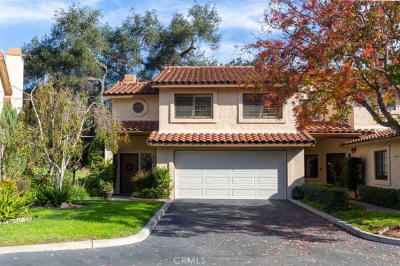 Front view of a two-story house with a double garage and a red-tiled roof.