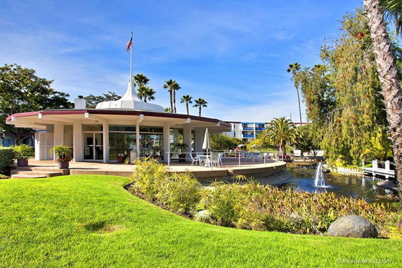 Front view of a circular building with a dome-like roof and surrounding patio area.