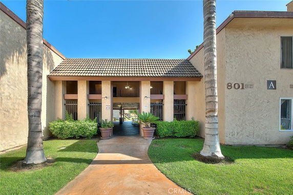 Front view of a building with tiled roof and columns at the entrance.