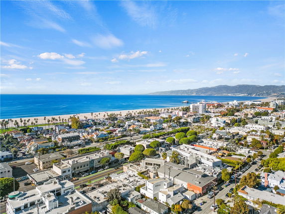 Panoramic view of a coastal cityscape with ocean and beach.