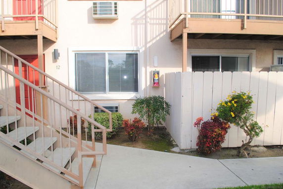 Front view of a multi-story building with exterior stairs.