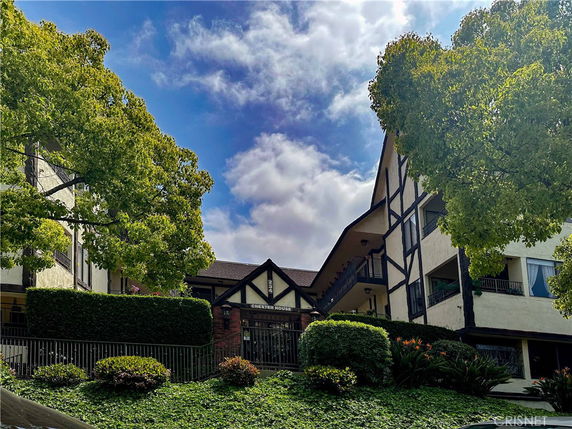 Front view of a multi-story building with Tudor-style architecture.