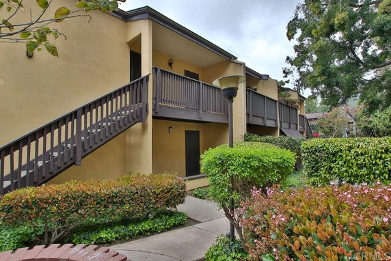 Front view of a two-story building with external staircase.