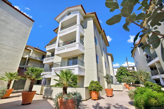 Front view of a multi-story apartment building with balconies.