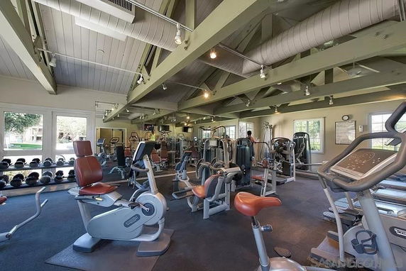 Interior view of a gym with various exercise equipment.