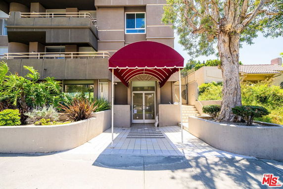 Front view of a building entrance with a red canopy.