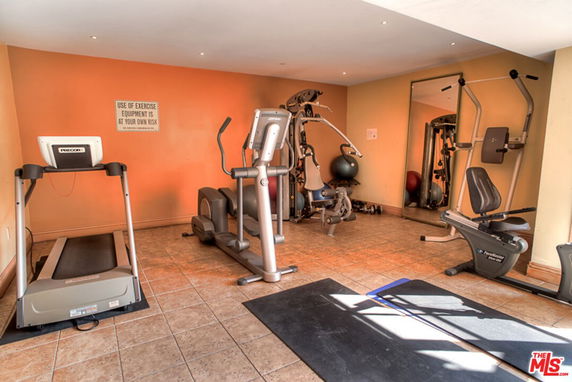 Indoor gym area with exercise equipment including treadmill and stationary bike.