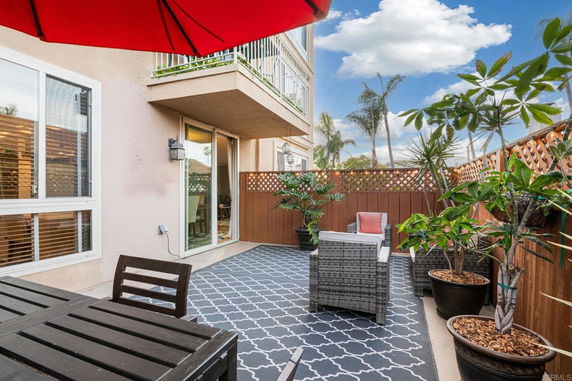 Outdoor patio area with seating and potted plants.
