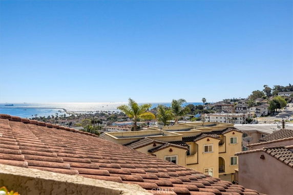View of a coastal area with houses and the ocean in the distance.