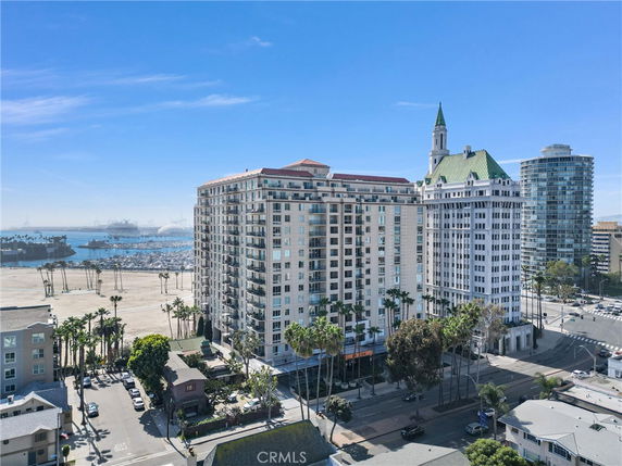 View of a seaside area with tall buildings near the coast and visible marina.