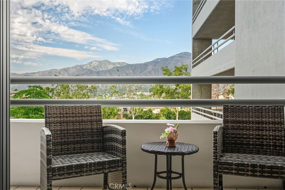 View from a building balcony with mountains in the distance.