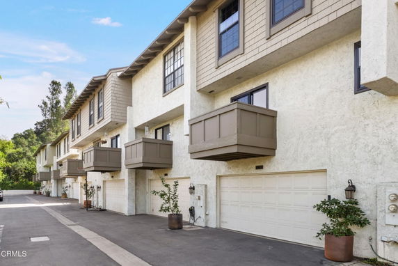 Front view of a multi-story residential building with garages.
