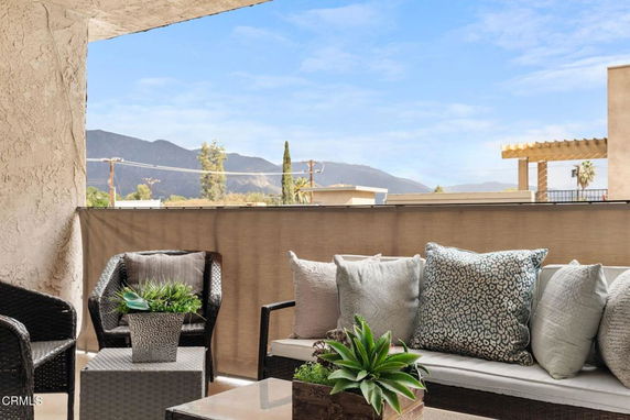 Outdoor seating area with distant mountains visible.