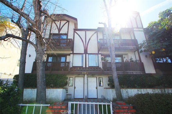 Front view of a multi-story building with balconies.