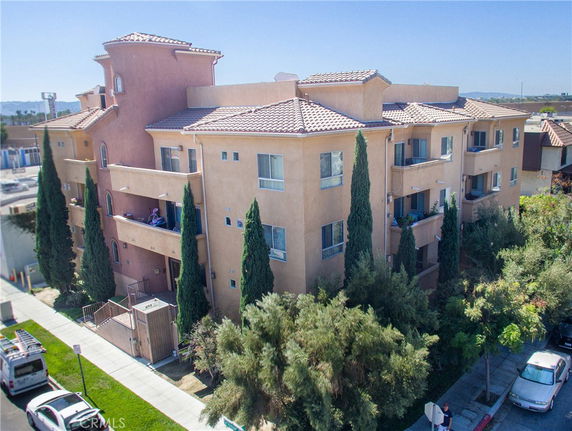 Front view of a multi-story residential building with balconies.
