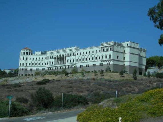 Front view of a large, multi-story building with classical architecture.