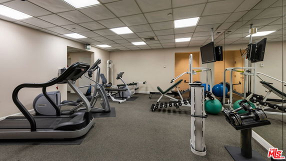 Indoor gym area with various exercise equipment.