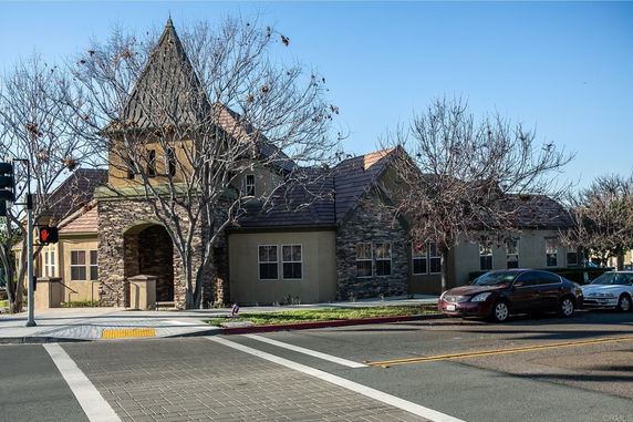 Front view of a house with steep roof and stone facade.