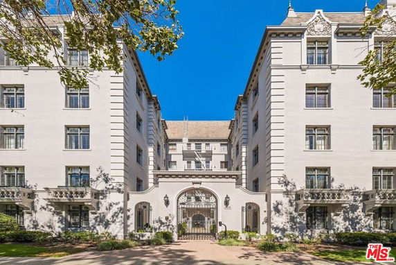 Front view of a multi-story building with a central archway entrance.