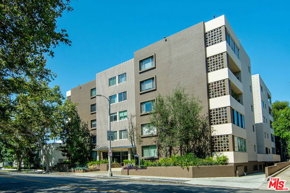 Front view of a multi-story apartment building with a modern design.