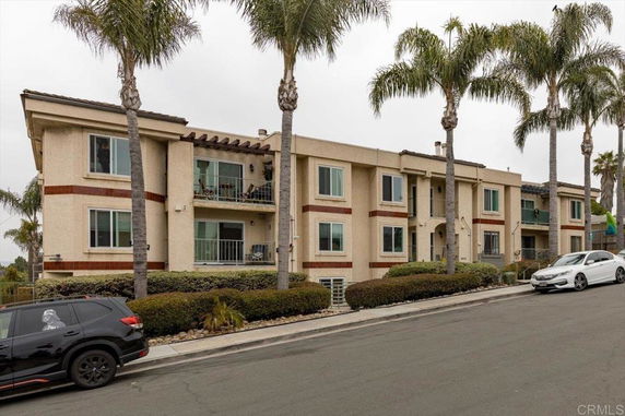 Front view of a two-story apartment building with balconies.