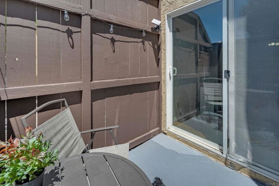 Small outdoor patio with a sliding glass door.