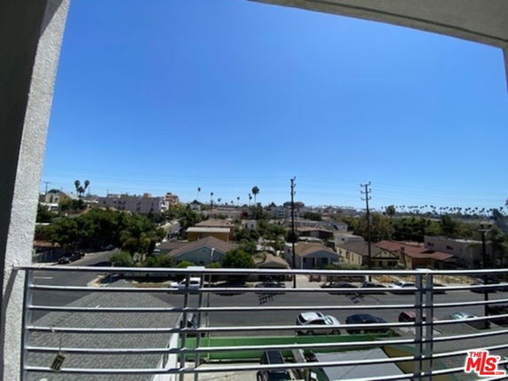 Panoramic view from a building showing surrounding residential area and landscape.