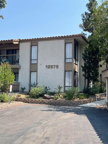 Front view of a two-story building with large windows and visible street number.