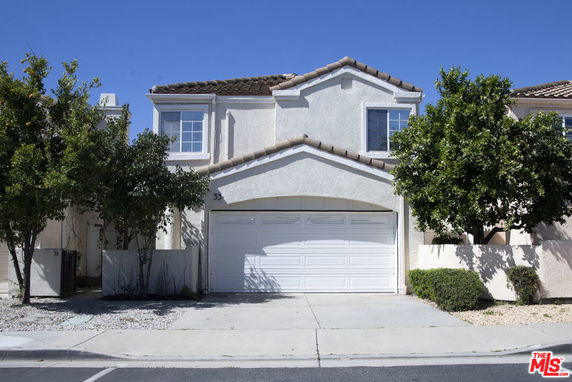 Front view of a two-story house with a double garage.