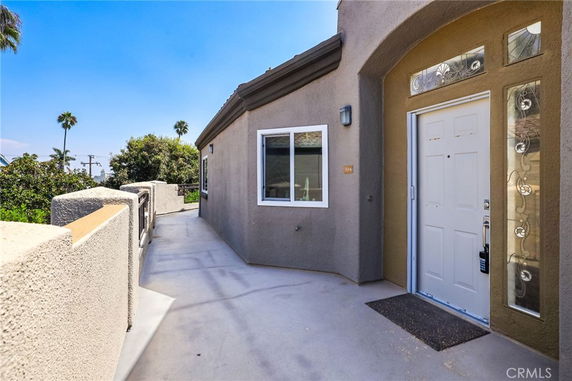 Front view of a house with a white door and decorative windows.