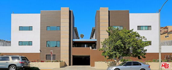 Front view of a modern apartment building with multiple stories.