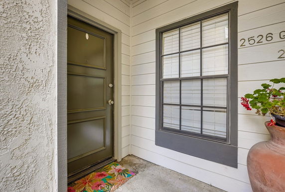 Front view of a building entrance with a door and window.