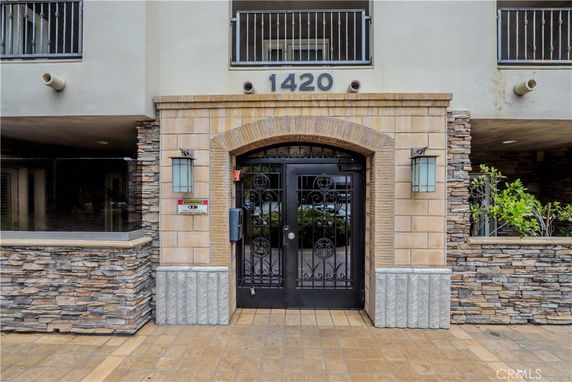 Front view of a building entrance with stone and brick facade.