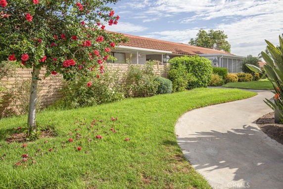 Front view of a single-story house with a tiled roof and landscaped garden.