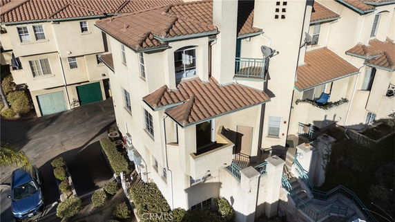 Front view of a multi-story residential building with brown tiled roof.