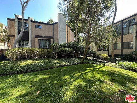 Front view of a multi-story building with large windows and geometric design elements.