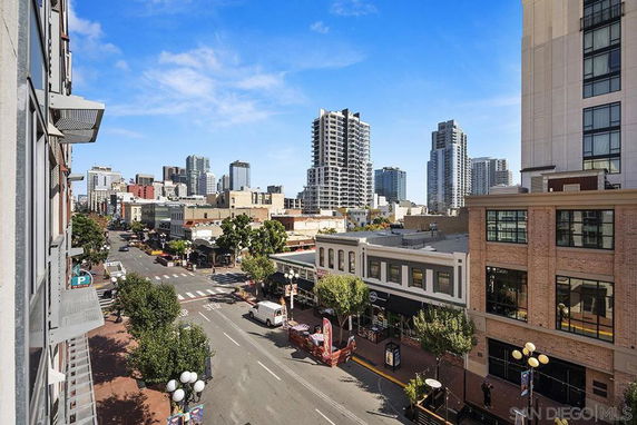 Urban view with multiple commercial and residential buildings and a street.