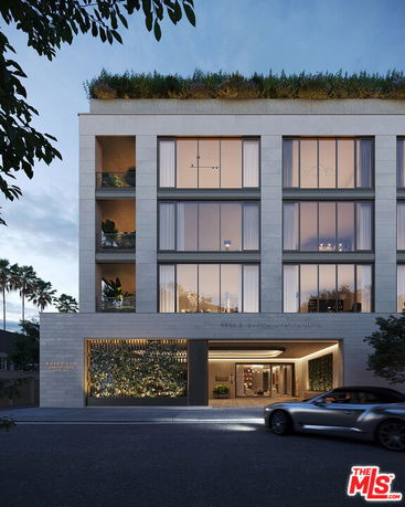 Front view of a modern multi-story building with large windows and a rooftop garden.