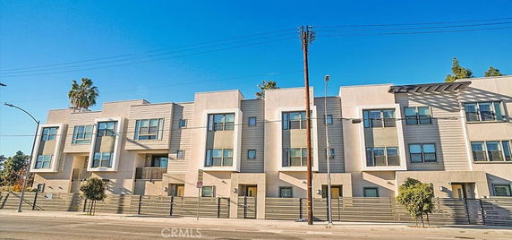 Front view of a multi-story apartment building with modern design.