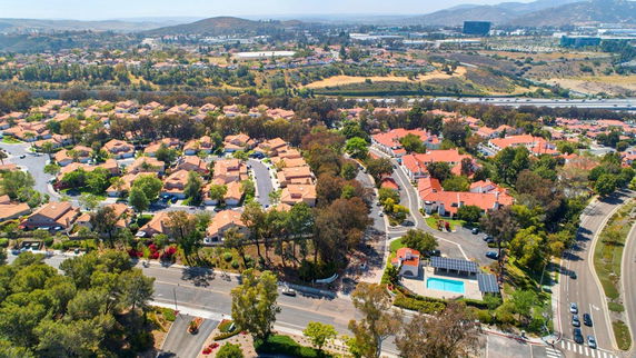 Panoramic view of a residential area with multiple houses and surrounding landscape.