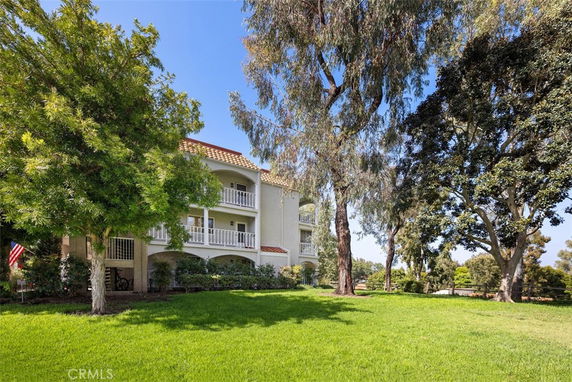 Front view of a multi-story residential building with balconies.