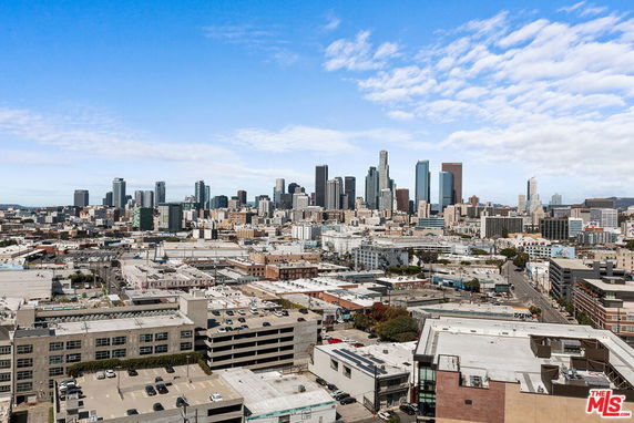 Wide angle view of a cityscape with numerous buildings and skyscrapers.