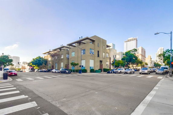 Front view of a multi-story building on a street corner.
